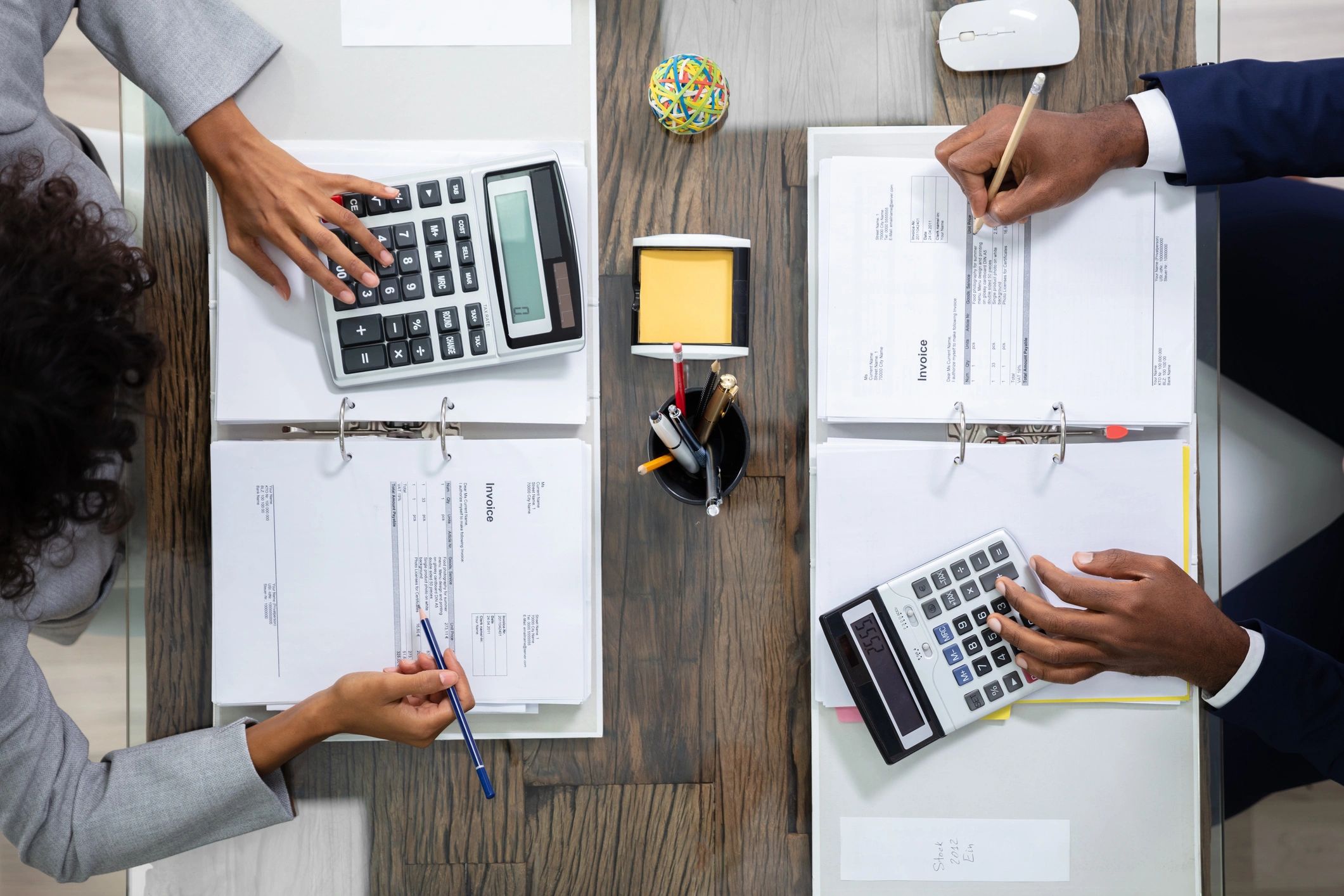 Business colleagues reviewing financial calculations